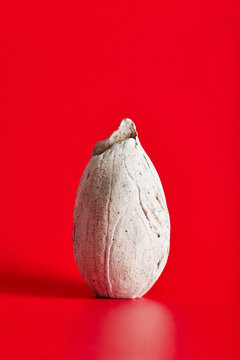 Minimalist ceramic sculpture on red background