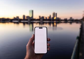 Hand Blank Cell phone screen night in  Boston skyline 