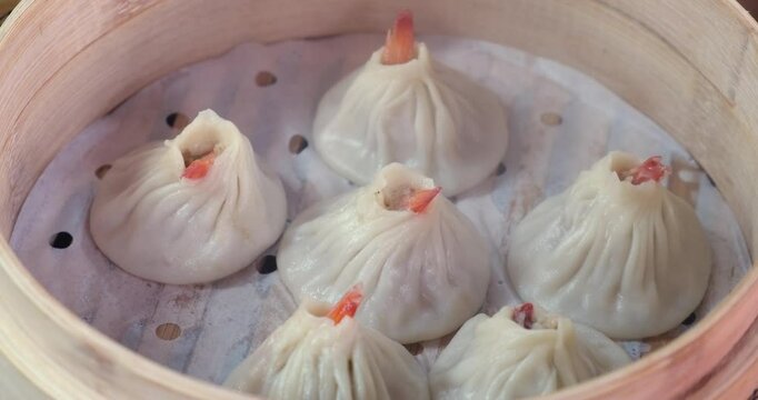 several Tangbao soup buns in steamer. Chinese food
