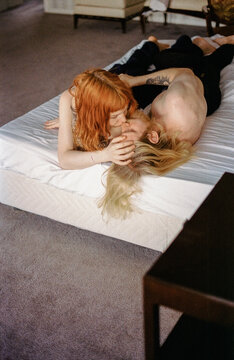 Man with beard and woman with red hair  kissing 