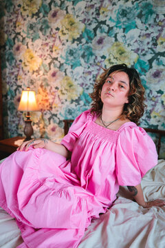 Confident Young Woman in a Pink Dress