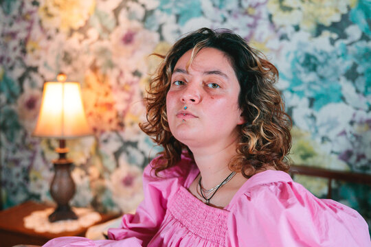 Confident Tattooed Young Woman in a Pink Dress