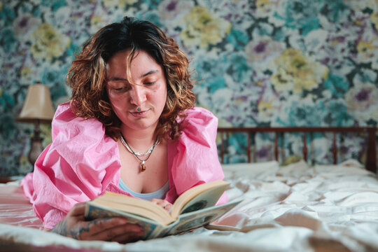 Woman reading a book in bed