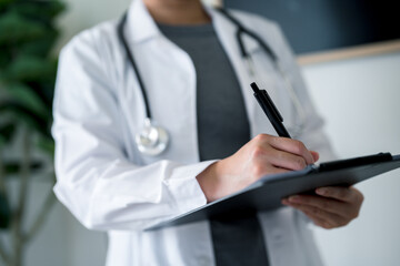 Doctor or nurse writing on clipboard in clinical. Patient data management, medical documentation, prescription handling and professional healthcare services to efficiency in treatment.