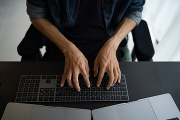 Asian man software engineer Working on Computer at office desk for writing program code IT Software...