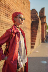 Gen z girl leather fashion with punk Asian woman tourist of local city Southeast Asia travel trendy...