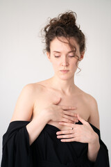 portrait of young beautiful woman with curly hair in studio