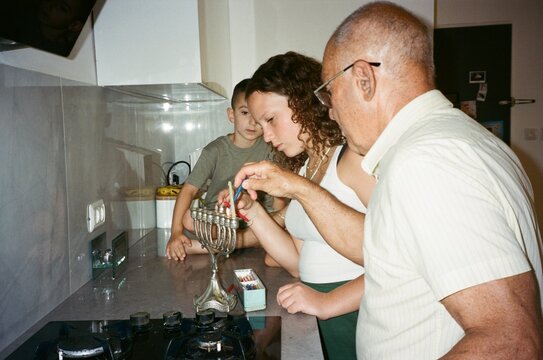 Family Celebration of Hanukkah With Traditional Menorah Lighting