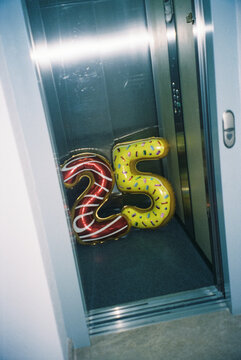 balloons forming the number 25 in an elevator, 35mm