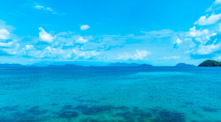 Nature of the beach and sea Summer with sunshine, sandy beaches, clear blue waters sparkling against the blue sky. On an island with good ecology and environment Background for summer vacation