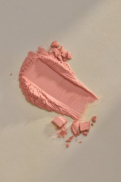 Crushed Pink Powder Blush Makeup On Beige Background