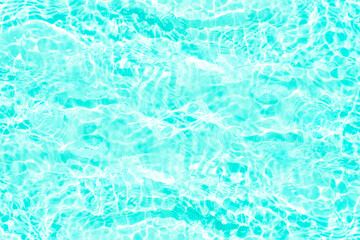 Blue water with ripples on the surface. Defocus blurred transparent blue colored clear calm water surface texture with splashes and bubbles. Water waves with shining pattern texture background.