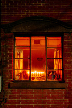Hanukkah candles in a window at night