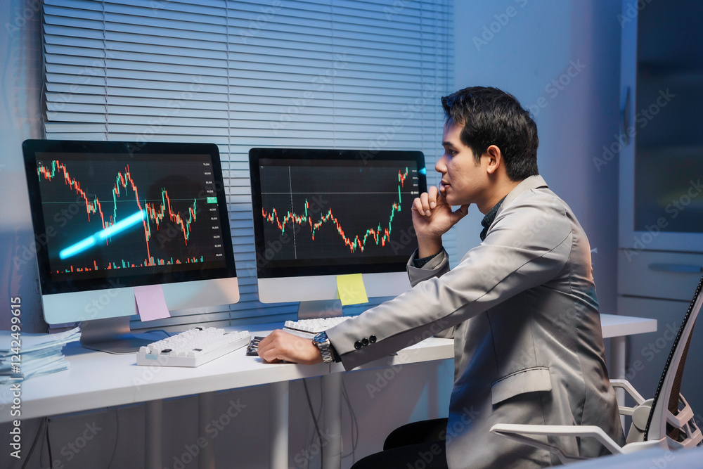 Poster stock trader analyzing charts on computer screens in office at night
