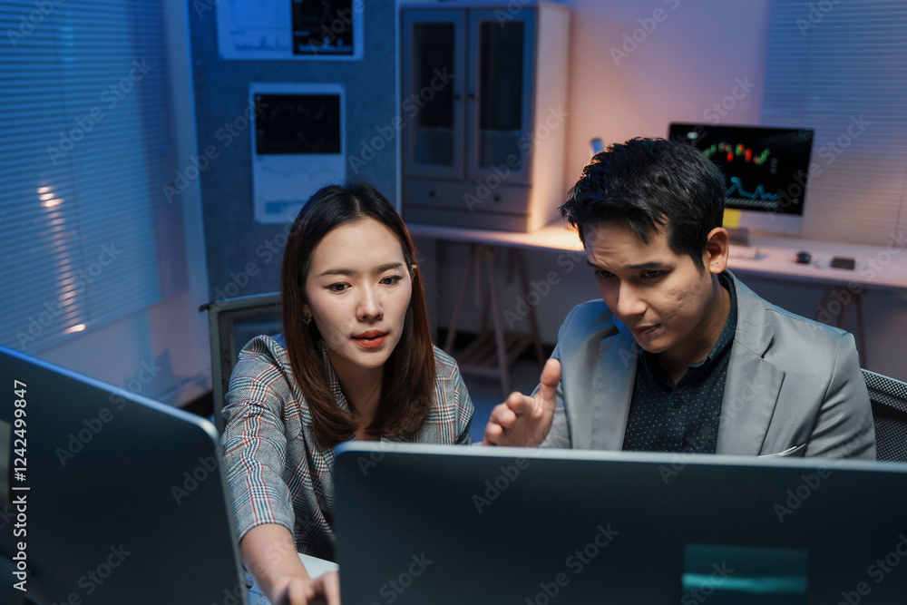 Poster asian business team working late analyzing financial data on computer in office