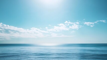 Fototapeta premium Serene Ocean Horizon with White Clouds Against a Blue Sky