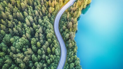Aerial view of road over blue lake water and green woods Beautiful summer landscape