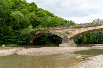 Fototapeta premium ancient stone bridge over the river