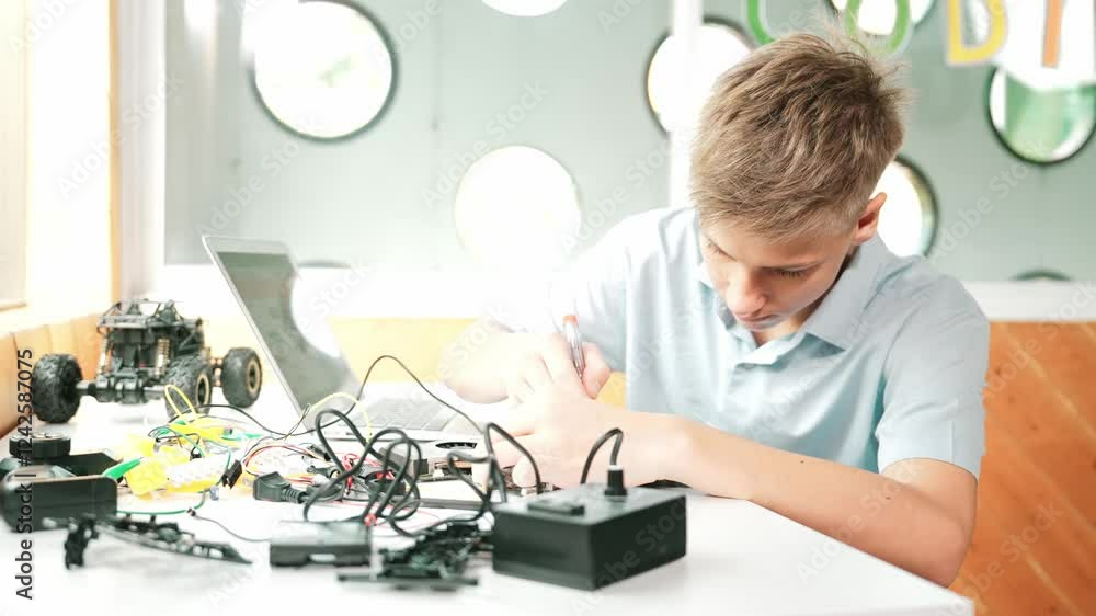 Poster caucasian boy fixing main board while study construction by using laptop analysis data. young techni