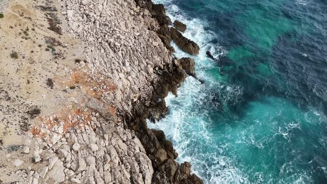 Mediterranean sae waves crash in to rocky beach in Calanques National Park near Cassis and Marseille in South France