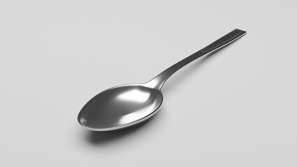 A chrome teaspoon on a grey table close-up.