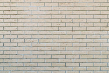 Textured brick wall background in light colors for design and decoration