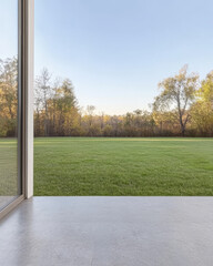 Spacious green landscape viewed from a modern home during early morning light