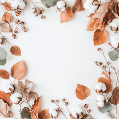 Autumn composition. Frame made of eucalyptus branches, cotton flowers, dried leaves on white background. Autumn, fall concept. Flat lay, top view, copy space