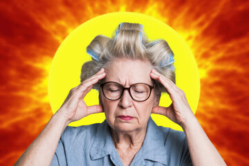 Portrait of an elderly woman in glasses and curlers holding her head and wincing from a headache, against the background of a large sun with solar flares and swirls of solar radiation
