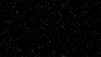 Falling snow isolated on black background. Nature Winter texture with motion real snowflakes in calm weather. Beautiful natural pattern of snow. 