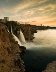 Obraz premium Lower Duden Falls at sunrise. The Mediterranean coast. Duden Waterfall ( Turkish: Düden Şelalesi ) is a popular tourist attraction of Antalya. Turkey country - vertical photo