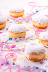 Berliner, carnival, donuts with paper streamers and confetti for carnival, holiday concept