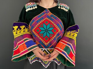 Black velvet tunic embroidered with national Palestinian ornament. Ethnic gown of Afghani tribe. Afghan embroidery on a cashmere dress. Middle Eastern embroidery pattern. Apparel with shoulder pads