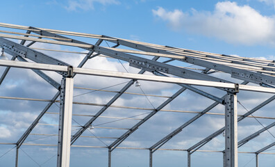 Architectural detail. Installation of metal structure outside. Metal construction. Structural design engineering. Structure engineering at building site. Framework construction architecture