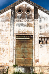 Facade of an old industrial warehouse that is next to an abandoned railway, on the little city in Brazil