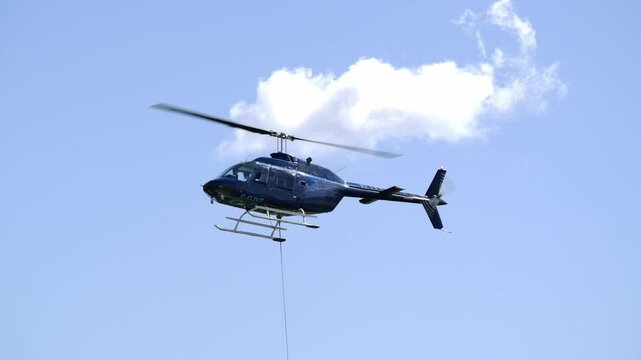 Low Angle Close Up View of a Flying Bell 206B Jetranger Helicopter III