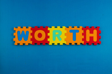 Fototapeta premium A close-up of foam puzzle pieces spelling out the word 