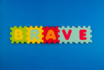 A close-up of foam puzzle pieces spelling out the word 