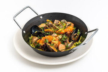 Top view of traditional Spanish seafood paella with rice, mussels and shrimps in a pan on stone table