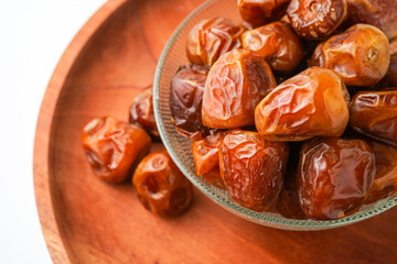 Dates fruit sukari or kurma sukari, in bowl isolated on white background
