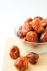Dates fruit sukari or kurma sukari, in bowl isolated on white background