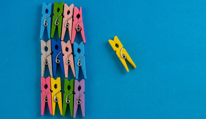 A solitary clothespin stands apart from the crowd, a lone figure against a vibrant backdrop of...