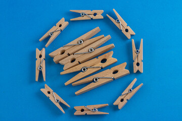 The clothespins form a circle of support, each one lending a helping hand, or rather, a gripping arm, to the others. The image evokes a sense of unity and shared responsibility.