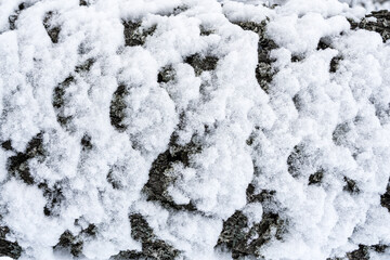Close-up of snow-covered surface creating a textured winter landscape.