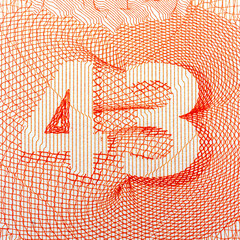 Close-up of intricate orange number 43 design on white background.