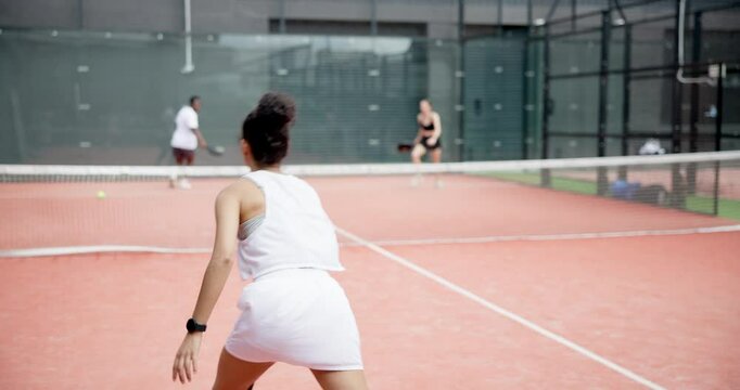 Woman, padel or training on court for competition, match or exercise with back outdoor. Players, team or racket sports for fitness, game or workout for body health with action for wellness or doubles