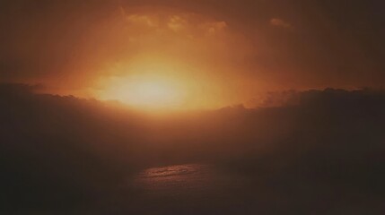 Obraz premium Stunning Sunrise Over Misty Mountains and Water: A Golden Hour Landscape