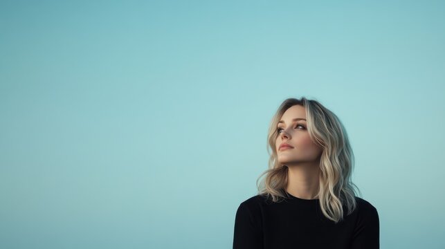 A professional portrait session showcasing a young woman set against the backdrop of a stunning clear blue sky at sunset, all captured within a photography studio