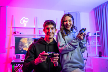 Portrait of Asian esport man and woman play game on computer together.  © Kawee