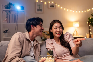 Asian young beautiful woman watching romantic movie on television at home.